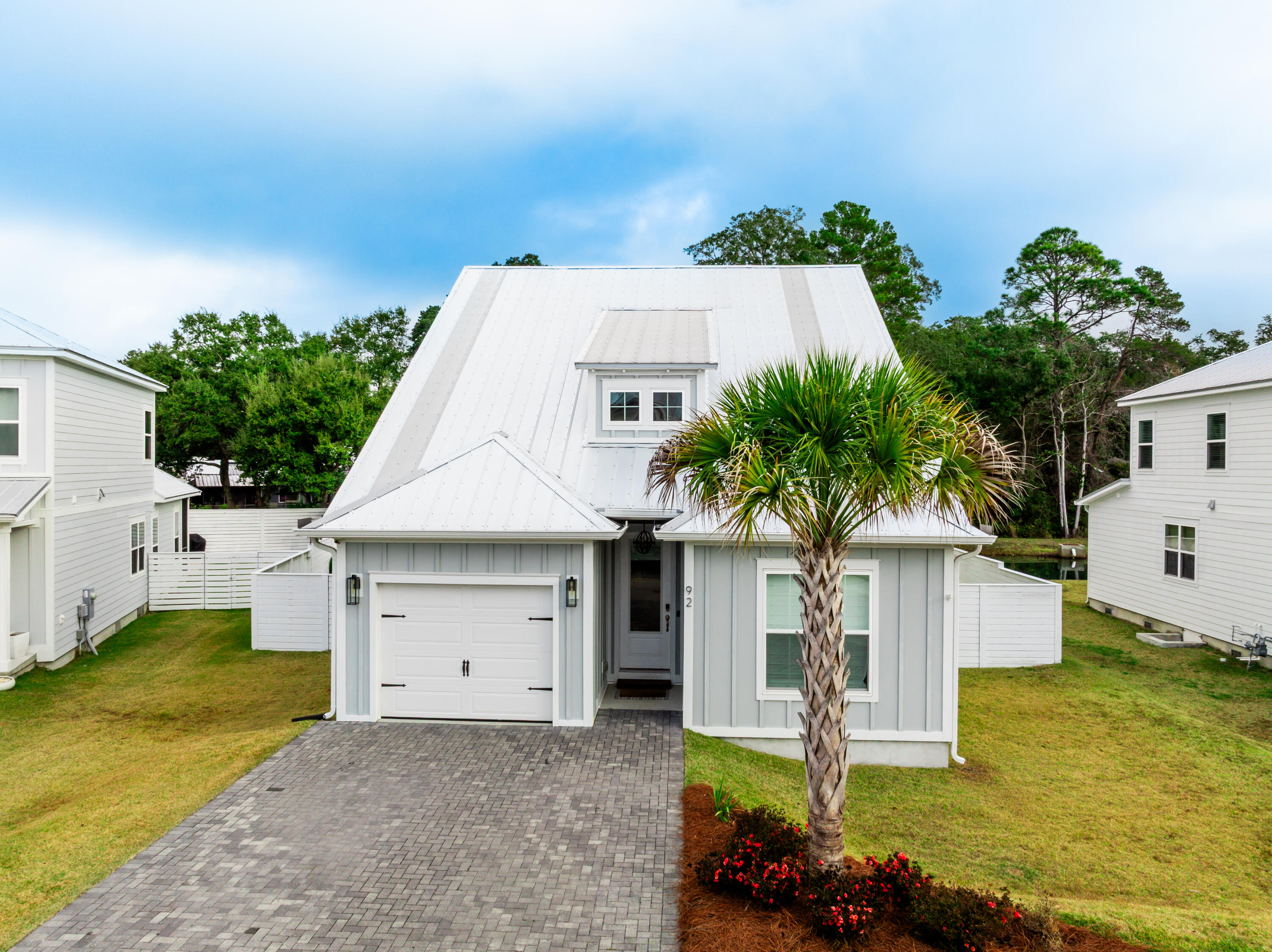 92 Bayou Edge Landing Santa Rosa Beach, FL 32459 - Photo 2 of 43 a front view of house with yard and swimming pool