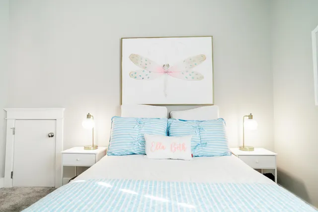 a bedroom with a bed and a painting on the wall