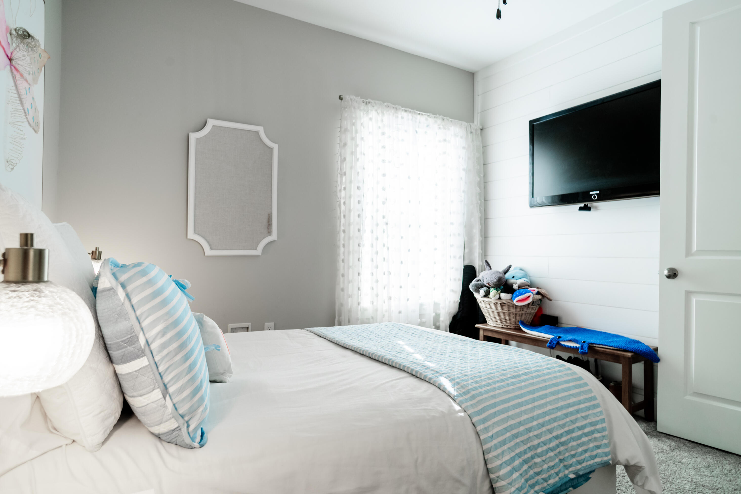 92 Bayou Edge Landing Santa Rosa Beach, FL 32459 - Photo 25 of 43 a bedroom with a bed and a flat tv screen on wall