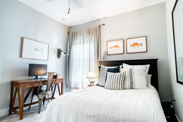 a bedroom with a bed and a desk