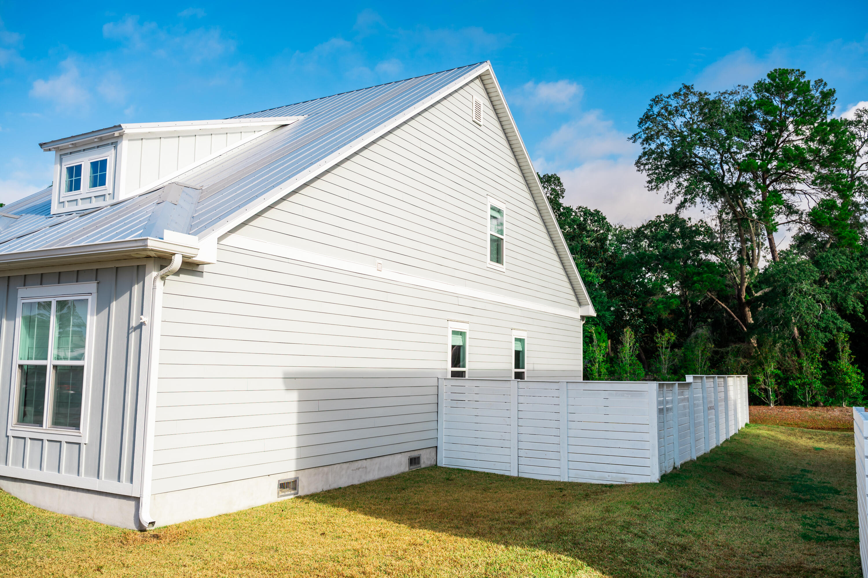 92 Bayou Edge Landing Santa Rosa Beach, FL 32459 - Photo 35 of 43 a view of a white house with a small yard and a large window