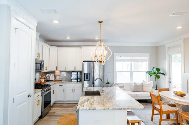 a living room with fireplace furniture and a chandelier