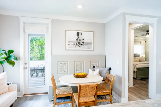 a view of a dining room with furniture and a potted plant