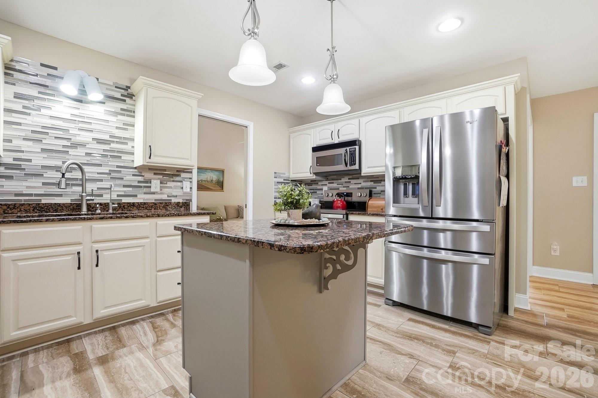 3324 Muddy Creek Road Midland, NC 28107 - Photo 13 of 46 a kitchen with stainless steel appliances granite countertop a refrigerator a stove a sink and a microwave