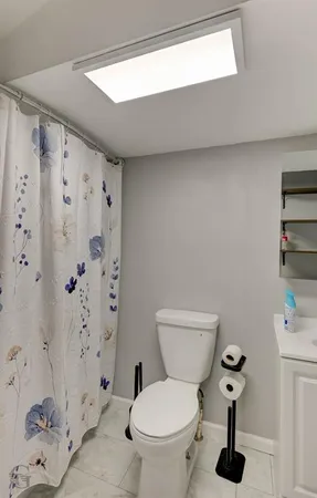 a bathroom with a toilet and a shower