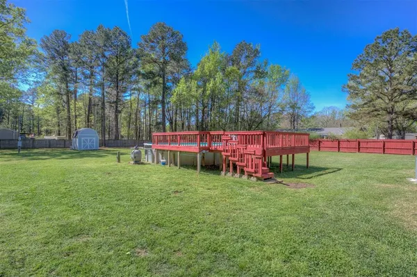 a view of yard with green space and deck