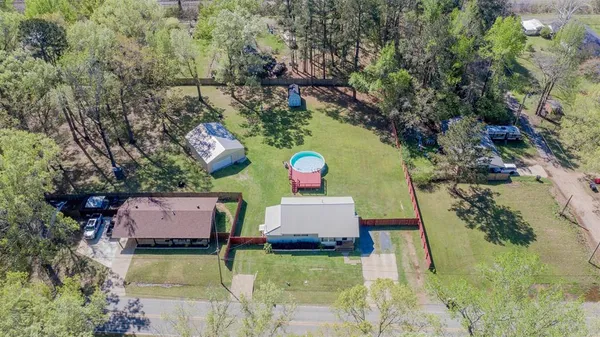 an aerial view of house with yard swimming pool and outdoor seating