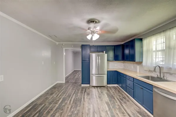 a kitchen with stainless steel appliances a refrigerator and a sink