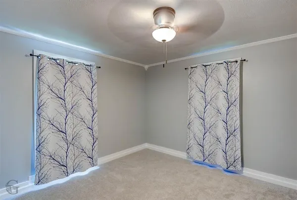 a view of a fan and a window in a room