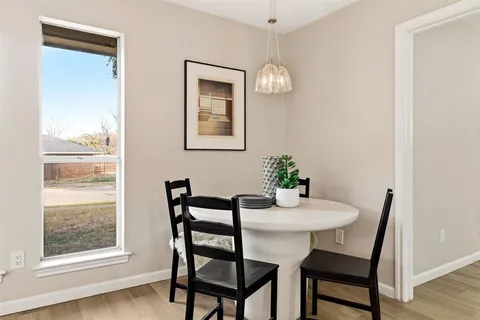 a dining room with furniture and window