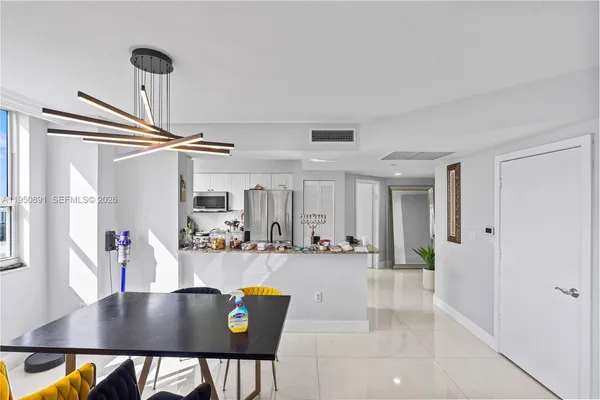 a view of kitchen and dining area with a sink