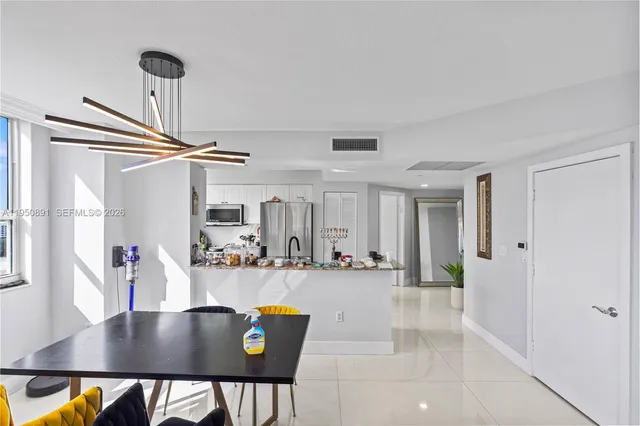 a view of kitchen and dining area with a sink