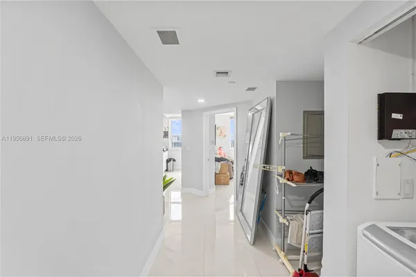 a view of entryway with workspace and wooden floor