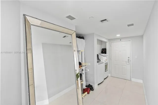 a room with white cabinets and white appliances