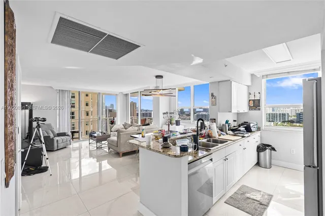 a kitchen with counter top space a sink and appliances