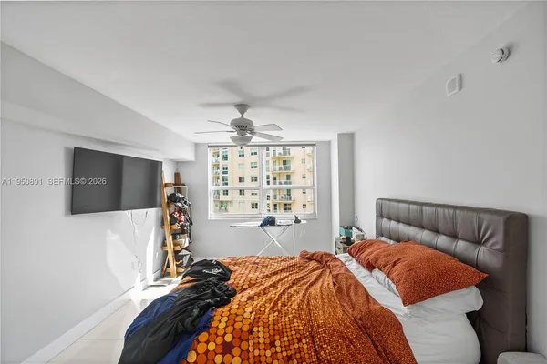 a bedroom with a bed and a flat screen tv