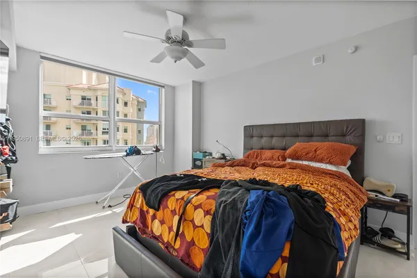 a bedroom with a bed and window