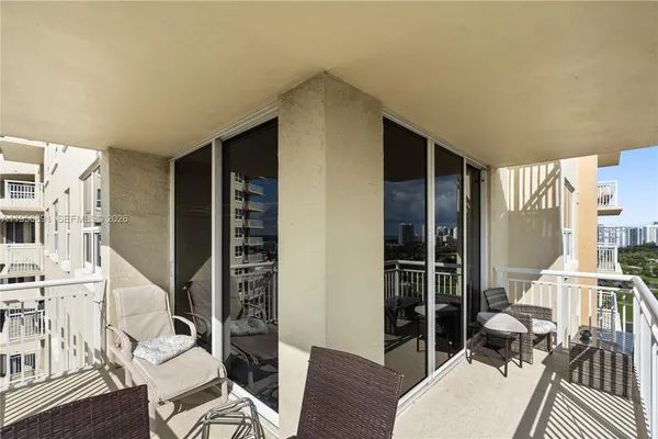 a living room with furniture a rug and white walls