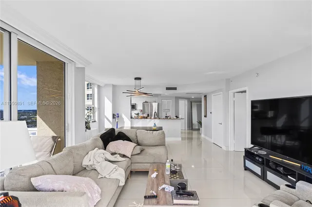 a living room with furniture and a flat screen tv