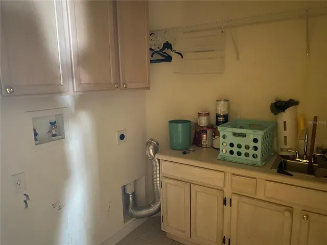 a kitchen with a sink and cabinets