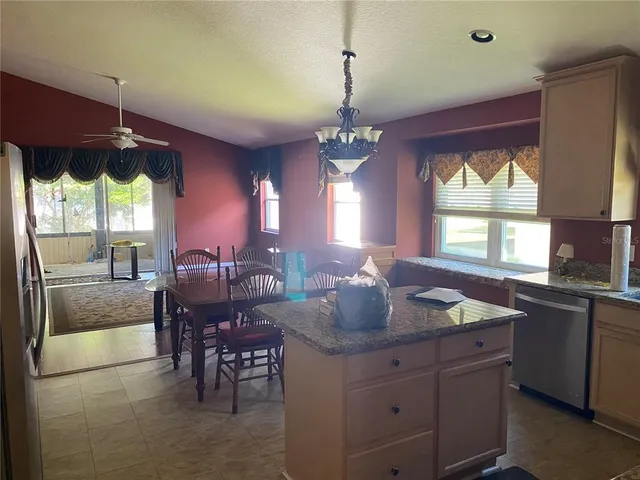 a kitchen with sink cabinets and dining table