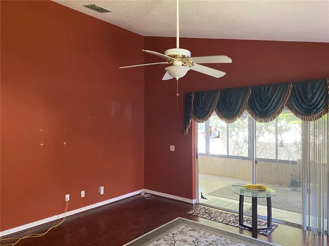a view of a room with a window and chandelier
