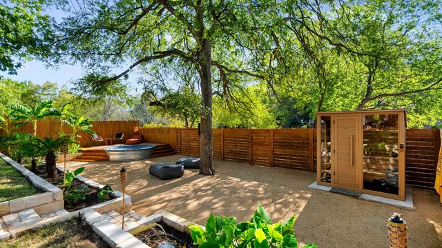 a view of a backyard with chairs and a fire pit