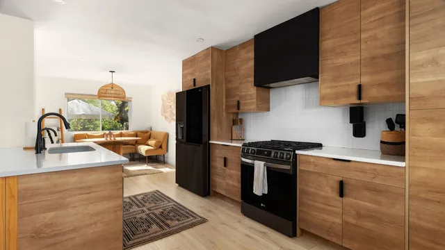 a kitchen with stainless steel appliances granite countertop a sink stove and refrigerator