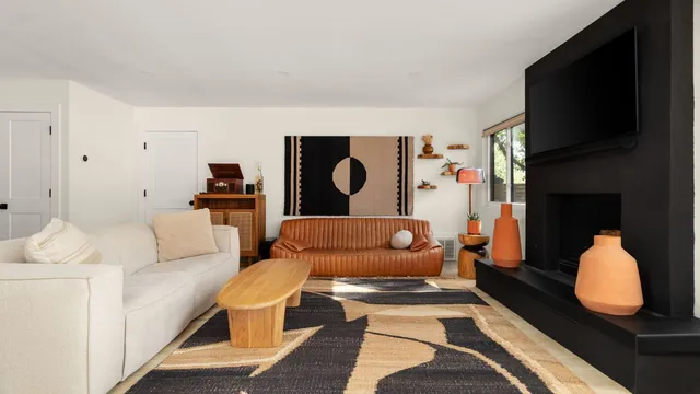 a living room with furniture fireplace and flat screen tv