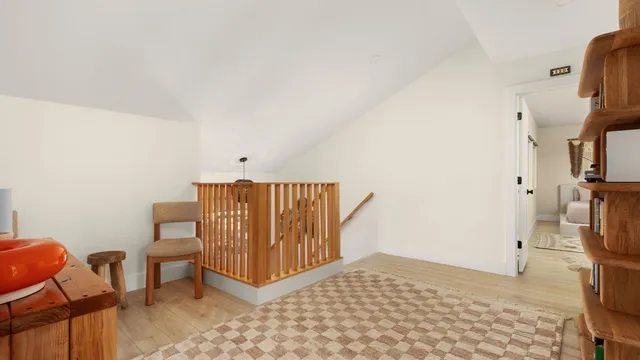 a bedroom with furniture and a rug