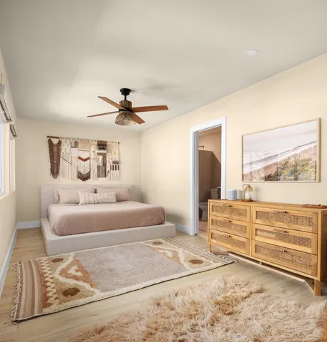 a spacious bedroom with a bed and a chandelier