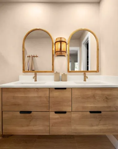 a bathroom with a double vanity sink and mirror