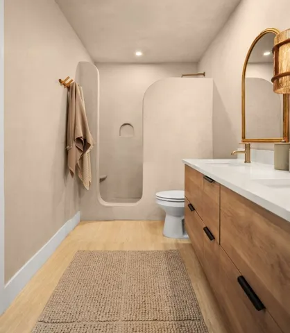 a bathroom with a granite countertop sink a toilet and a mirror