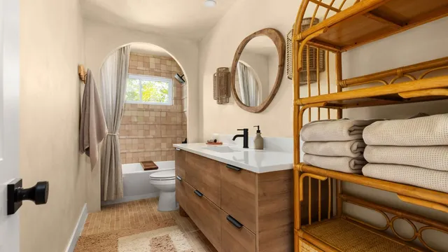a bathroom with a granite countertop toilet a sink and a mirror