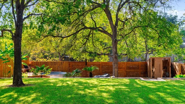 a backyard of a house with table and chairs