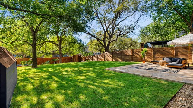 a view of yard with green space and seating area