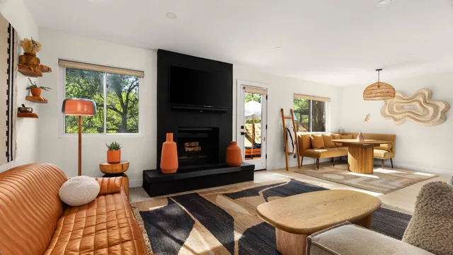 a living room with furniture fireplace and flat screen tv