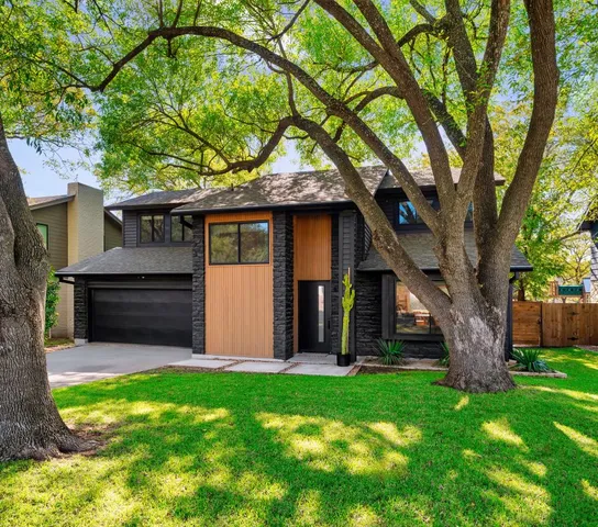 a front view of house with yard and green space