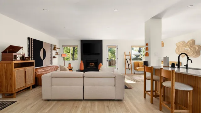 a living room with furniture a fireplace and a flat screen tv