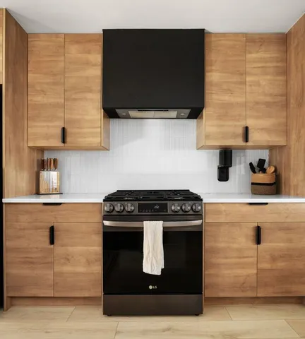 a kitchen with stainless steel appliances granite countertop a stove and a microwave