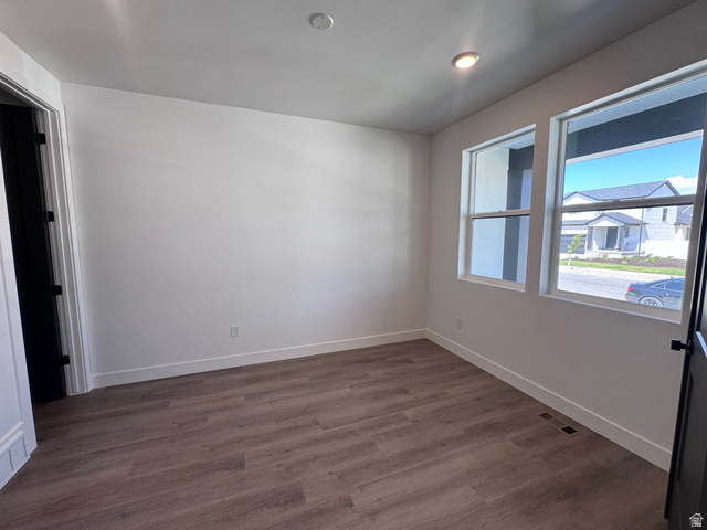 1301 1475 East, Unit 33 Payson, UT 84651 - Photo 3 of 10 Spacious room featuring wood-finish flooring, white baseboards, and two windows providing outdoor illumination