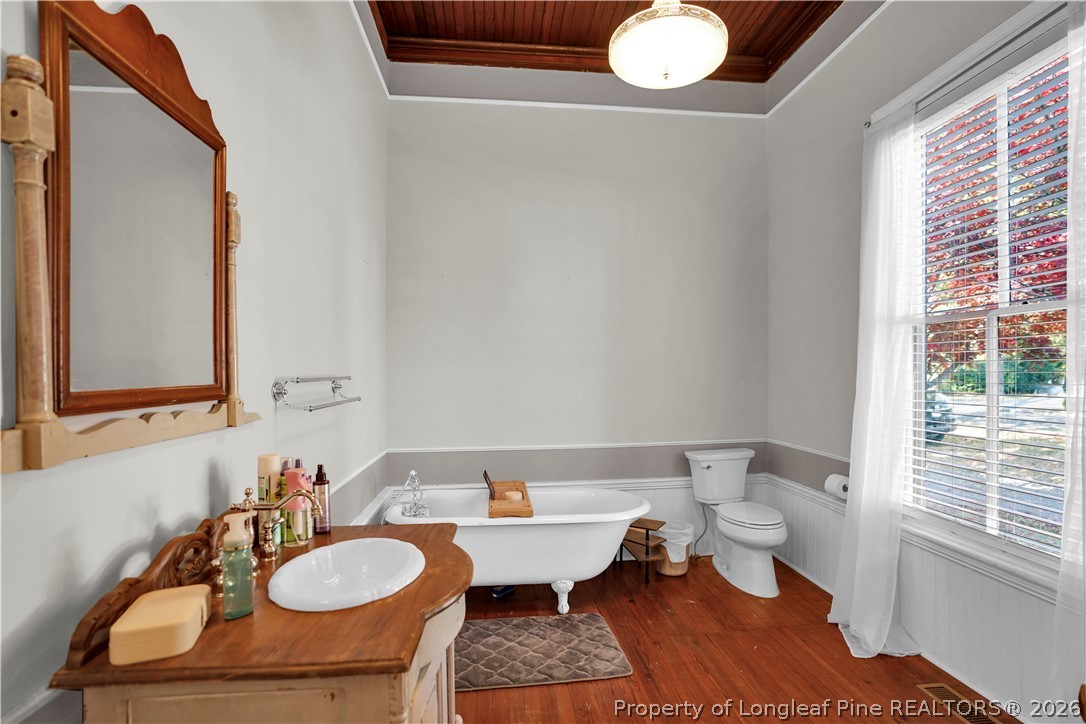 115 North Magnolia Street Raeford, NC 28376 - Photo 14 of 29 a bathroom with a sink mirror and a toilet