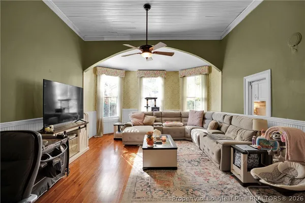 a view of a hallway with wooden floor and staircase
