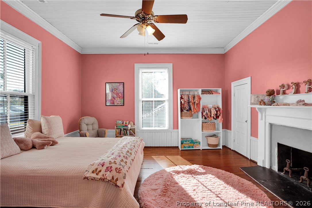 115 North Magnolia Street Raeford, NC 28376 - Photo 25 of 29 a bedroom with a bed and a fireplace
