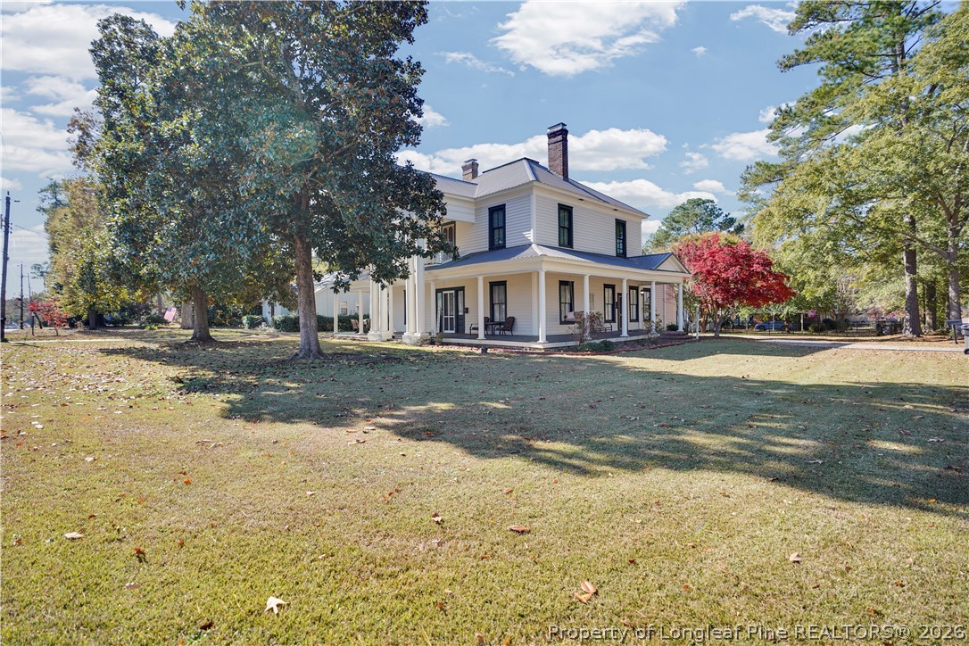 115 North Magnolia Street Raeford, NC 28376 - Photo 29 of 29 a front view of residential houses with yard and trees