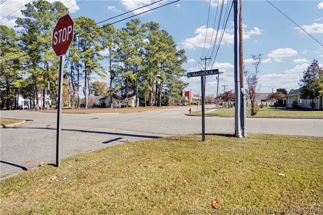 115 North Magnolia Street Raeford, NC 28376 - Photo 3 of 29 a street sign on a sidewalk next to road