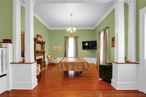 a view of a dining room with furniture window and wooden floor