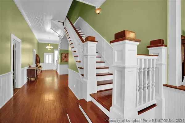 a living room with furniture a chandelier and a window
