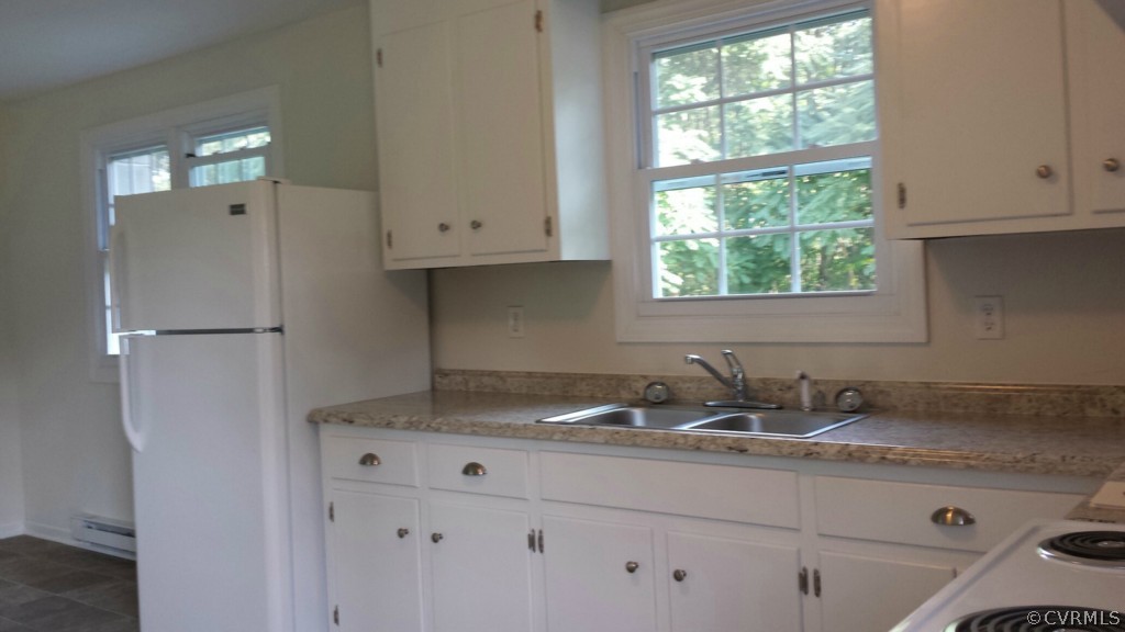 689 Sheppards Road Farmville, VA 23901 - Photo 5 of 16 a kitchen with granite countertop a sink window and cabinets