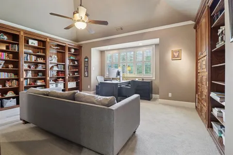 a living room with furniture and a bookshelf